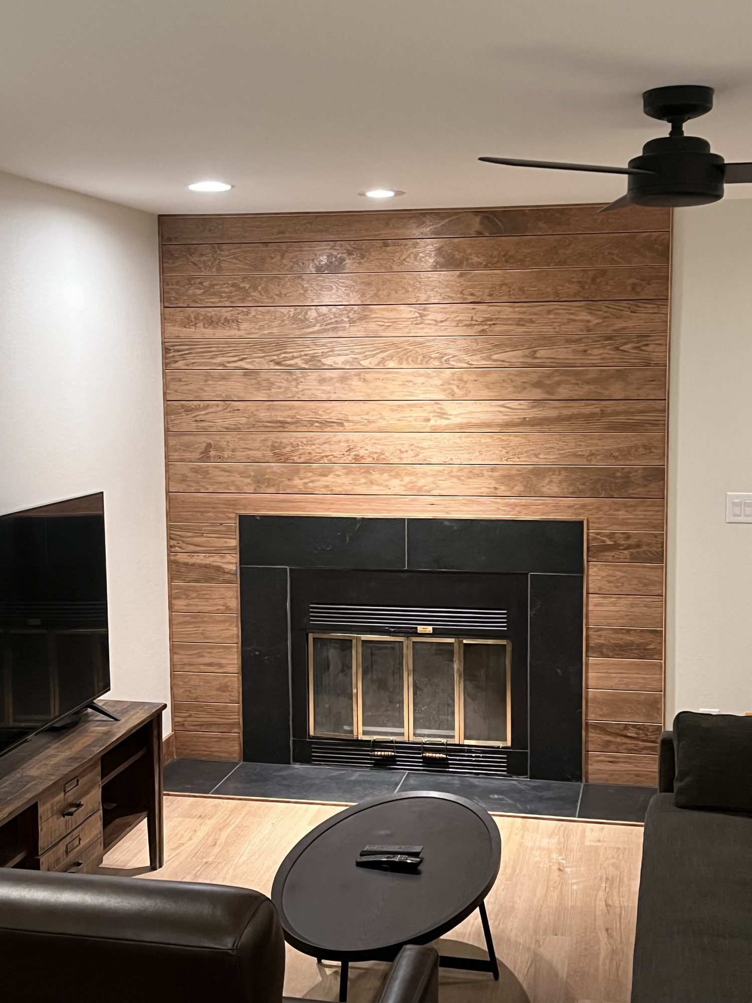 Living room with a wood plank fireplace wall