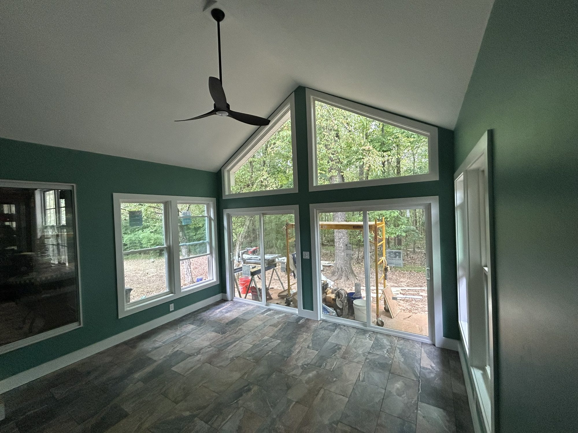 Sunroom with a vaulted ceiling, gable windows and tile floor