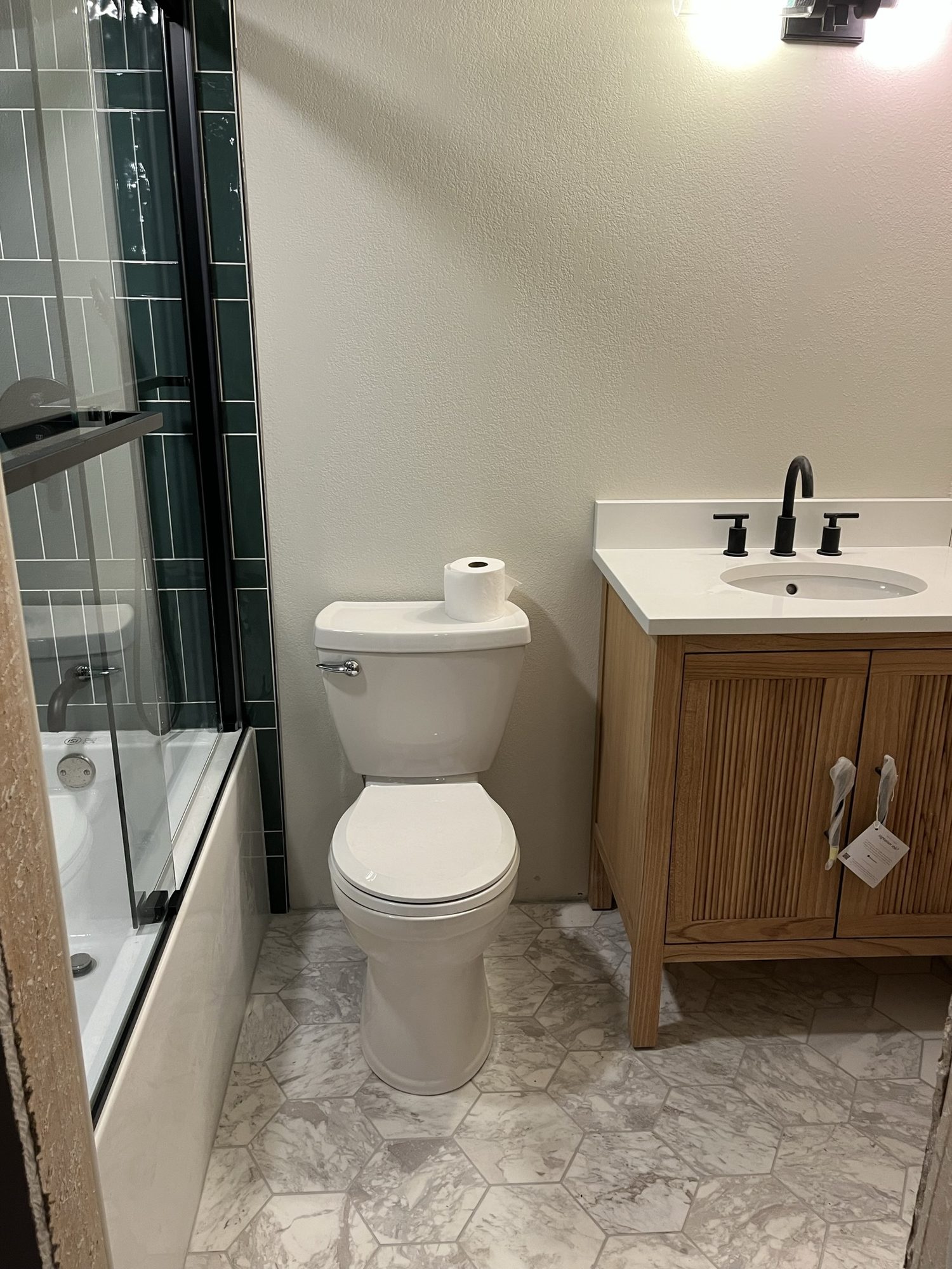 Wood bathroom vanity with a white top